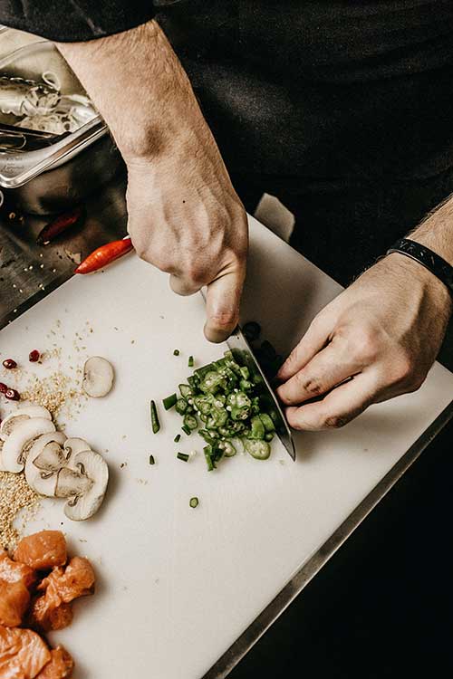 Chef Jose Mier chopping herbs