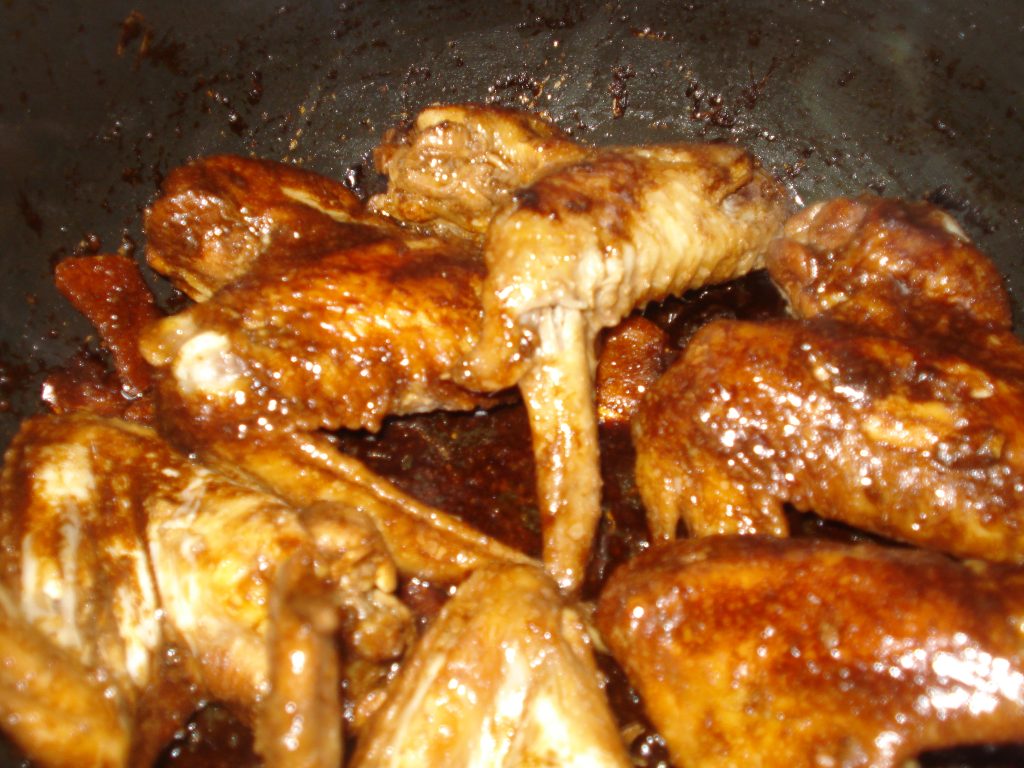 Jose Mier Filipino chicken adobo pieces braised in a dark, glossy sauce in Sun Valley kitchen